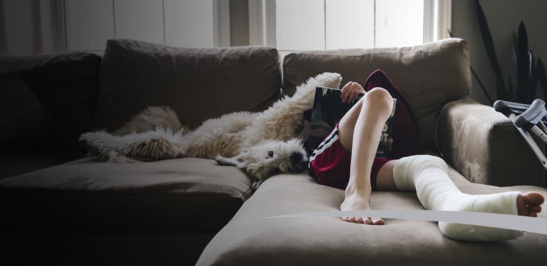 boy with broken leg sitting on a couch