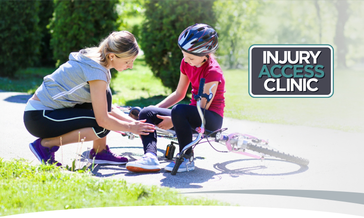 Photo: Mom checks daughter's injured leg after a bike fall